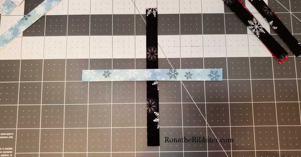 Place the first 2 strips for Scandinavian Christmas Star ornament